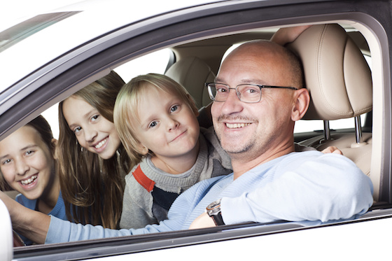 happy father with children in the car